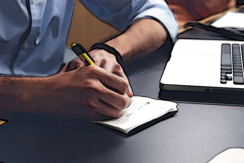 Man writing notes on a paper